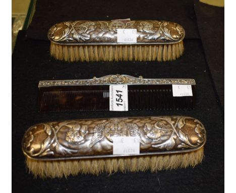 A pair silver clothes brushes, repousse cherubs, Birmingham 1905; a silver mounted comb (3)