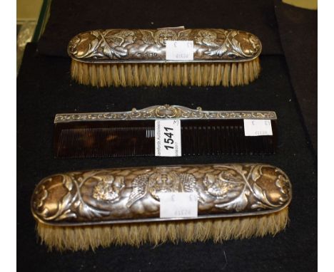 A pair silver clothes brushes, repousse cherubs, Birmingham 1905; a silver mounted comb (3)