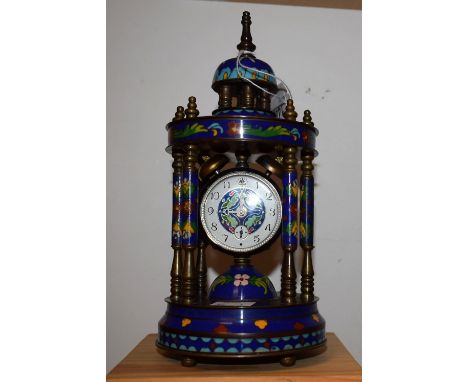 A cloisonne portico clock, domed top supported by six columns, ornamental dial, ball feet