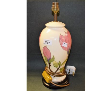 A contemporary Moorcroft Magnolia pattern baluster lamp, tube lined with large pink flowerheads on a white ground, 29cm high,