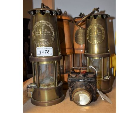 An Eccles miners lamp; another, similar; a wooden model of a miners lamp; another, similar; a square torch (5)