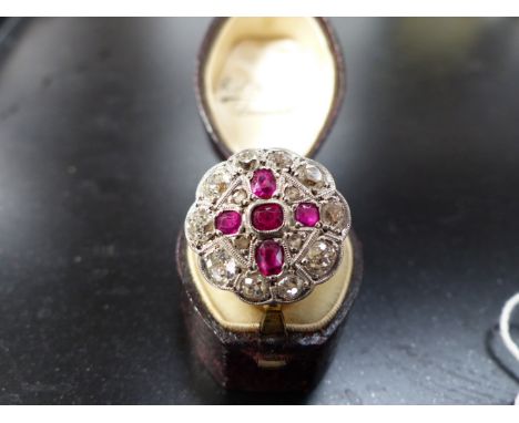 AN 18CT GOLD AND PLATINUM DIAMOND AND RUBY CLUSTER RING