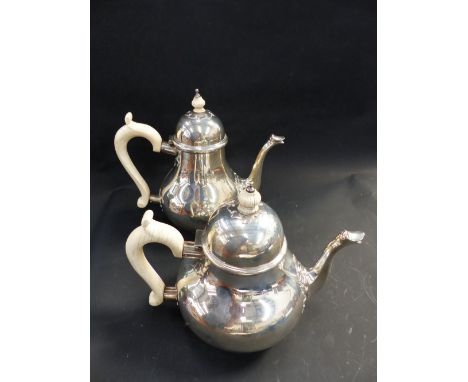 A SILVER MATCHING TEAPOT AND COFFEE POT WITH IVORY HANDLES AND FINIALS. LONDON 1943/4 BY GARRARD & CO. 54 ozs IN TOTAL