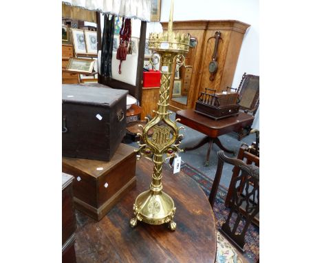 A BRASS GOTHIC REVIVAL LARGE PRICKET ALTAR CANDLESTICK, ELABORATE PIERCED BANDING AND MOUNTED WITH GLASS INSETS. 88CM HIGH