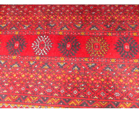 AN AFGHAN BOKHARA CARPET. 305 X 203CM