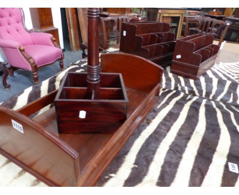 AN ANTIQUE MAHOGANY BOOK TROUGH TOGETHER WITH TWO MAHOGANY STATIONERY RACKS AND FOUR BOTTLE WINE CARRIER.