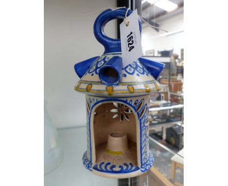 A DUTCH GOUDA TYPE POTTERY CANDLE LANTERN WITH BLUE AND WHITE DECORATION RETAILED BY LIBERTY & CO. H.23cms
