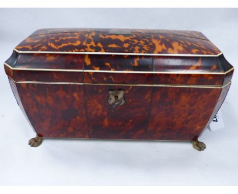 A LARGE REGENCY TORTOISESHELL INLAID SARCOPHAGUS FORM TEA CADDY WITH FITTED INTERIOR.
