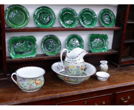 A COPELAND SPODE JUG AND WASH BOWL SET WITH POLYCHROME PHOENIX BIRD DECORATION AND NINE MOULDED GREEN GLAZE DISHES.