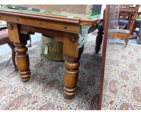 AN EARLY 20TH.C.MAHOGANY SNOOKER/DINING TABLE COMPLETE WITH CUES AND BALLS.