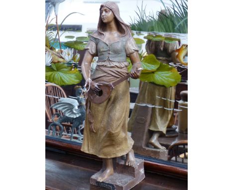 A GOLD SHEIDER PATINATED EARTHENWARE FIGURE OF A GIRL PLAYING A STRINGED INSTRUMENT ENTITLED MICHON. H.78cms