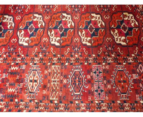 AN ANTIQUE TEKKE BOKHARA MAIN CARPET. 290 X 265CM