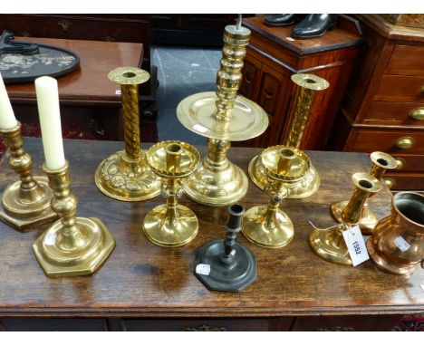 FOUR PAIRS OF ANTIQUE AND LATER BRASS CANDLESTICKS, A BELL METAL MEASURE, A TAPER STICK AND A HEEMSKERK TYPE PRICKET CANDLEST