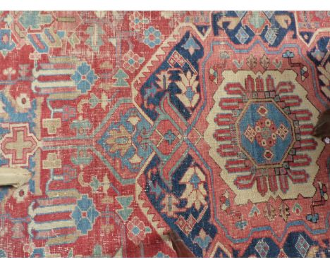 AN ANTIQUE PERSIAN HERIZ CARPET