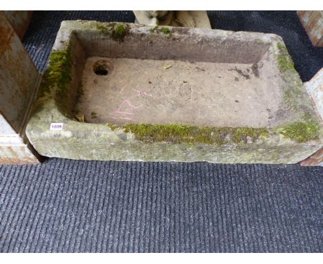 AN ANTIQUE CARVED STONE GARDEN TROUGH.