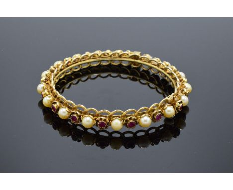 Quality silver gilt bangle set with ruby and pearl stones. 