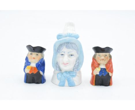 Royal Worcester miniature Toby jugs in blue and red colourways together with a Mrs Caudle candle snuffer (3). In good conditi