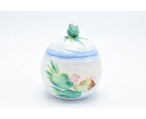 Clarice Cliff (Newport Pottery) preserve pot in the Apple Blossom design with a bud finial. In good condition with no obvious
