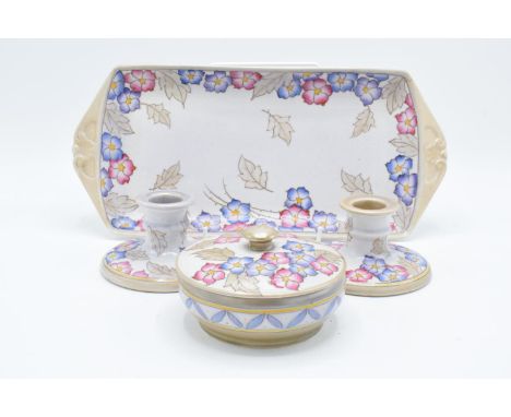 A collection of Bursley Ware Charlotte Rhead pottery in a tubelined floral design 'TL4' to include a pair of candlesticks, a 