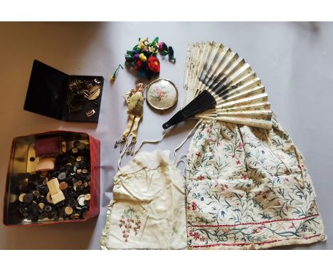 An embroidered lid on brass feed, an embroidered drawstring bag, 1900 (some marks) and a Georgette, cream and green drawstrin