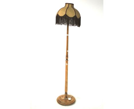 A contemporary floor lamp. With turned baluster stem and fringed Art Deco-style shade, 174cm high