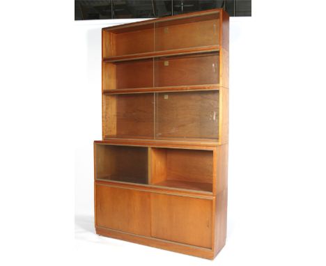 A 1960s Danish style light mahogany five tier display cabinet. Each tier with sliding glass doors, above a pair of sliding wo