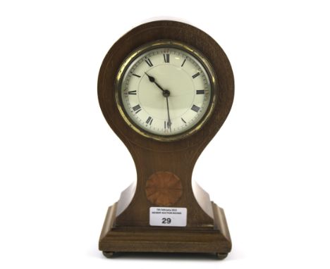 A 20th century balloon shaped mantel clock. The enamel dial with Roman numerals, within a inlaid mahogany case, raised on a p