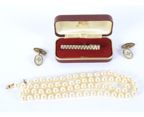 A saltwater pearl necklace, pair of gilt cufflinks and a tie pin. The necklace 64cm long, the cufflinks of oval form with mot