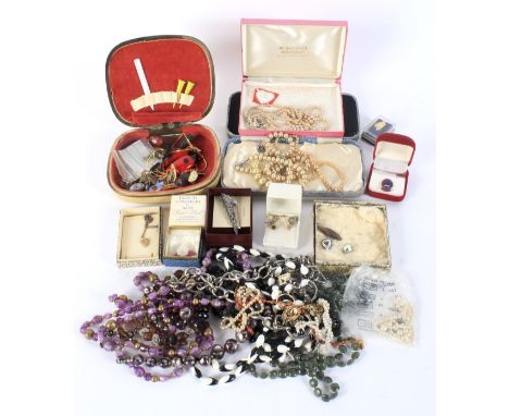 An assortment of costume jewellery. Including a white metal pendant, a jet bead necklace, synthetic pearl earrings, silver pl