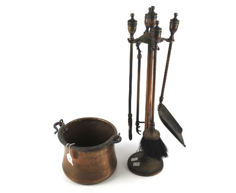 A copper pot and a set of four fireside tools. The pot with a cast iron handle 17cm high, the fireside tools on a metal stand