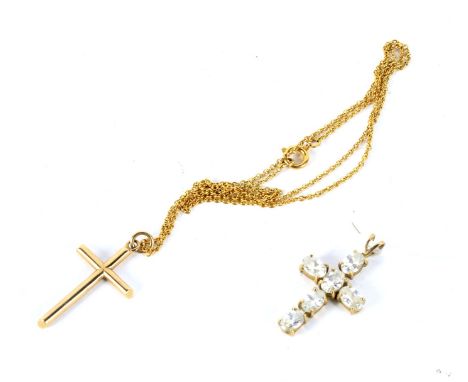 A modern 9ct gold cross pendant and a yellow metal mounted cross pendant and chain. The gold cross hallmarked Birmingham 1992