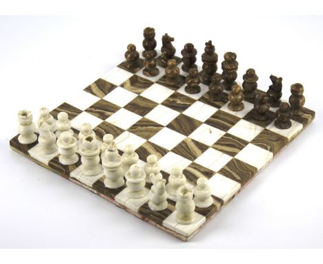 A brown and white marble chessboard and a matching full chess set. 29cm x 29cm (one of the white pawns is damaged)