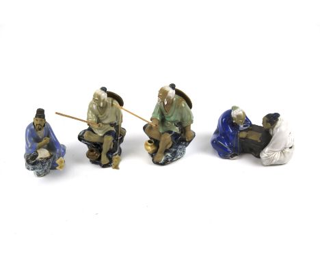 Four 20th century Chinese ceramic figures. Two modelled as fisherman, another as an artist and the fourth of two scholars pla