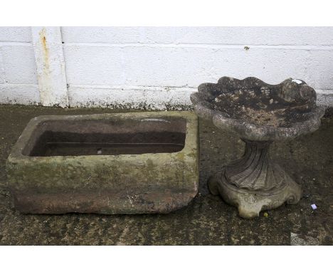 Stone garden trough of rectangular form and a composite stone bird bath in the form of a shell on stand. The trough L68cm x D