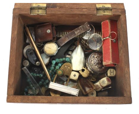 A mahogany box containing an assortment of collectables. Including coins, a compass, cufflinks, RAF badge, dice and folding s