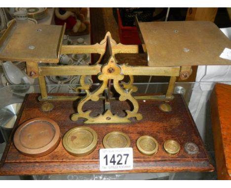 A set of Victorian brass postal scales with weights.