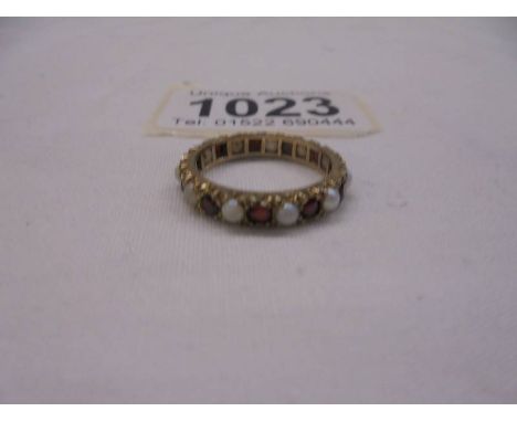 A ruby and opal yellow gold eternity ring, size M, 2.5 grams