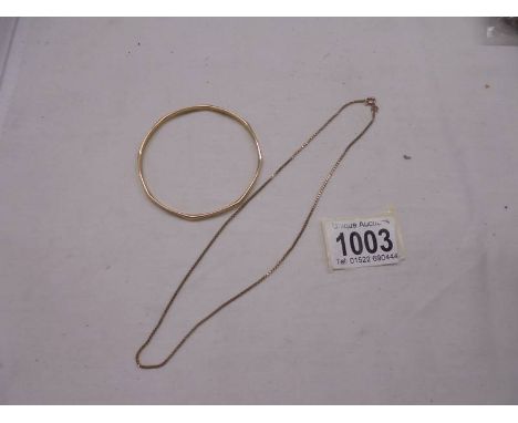 A 9ct gold bangle and a 9ct gold neck chain, 16.69 grams.