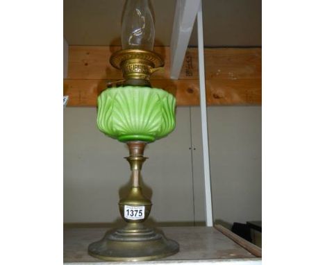 A Victorian oil lamp with green glass font, in good condition, COLLECT ONLY.