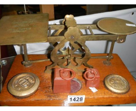 A set of Victorian brass postal scales with weights.