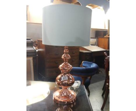 A copper table lamp.