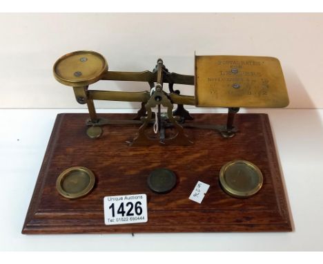 A set of Victorian brass postal scales with weights.