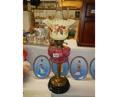 A Victorian oil lamp with cranberry glass font and original shade, COLLECT ONLY.