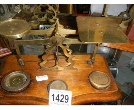 A set of Victorian brass postal scales with weights.