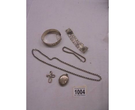 A silver bangle, silver neck chain, silver bracelet, silver locket and silver cross etc., 99 grams (3 ounces).