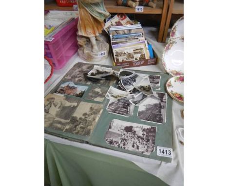 A part album and a box of vintage postcards.
