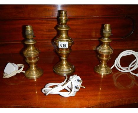 Three brass table lamp bases.