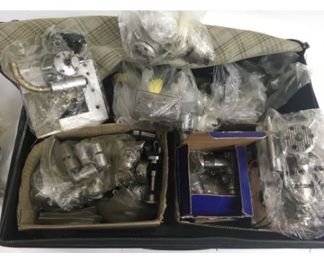A suitcase containing a collection of new "Performance " engines for model boats etc