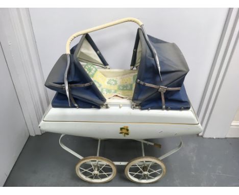 A vintage doll's pram and bedding