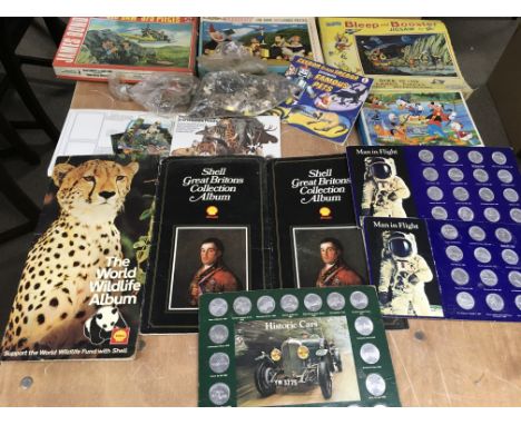 A collection of vintage jigsaws including Bleep and Booster and James Bond. Also a collection of Shell coin and card sets
